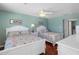 Bedroom showcasing two beds, stylish furniture, and a relaxing atmosphere at 13500 Gulf Blvd # 506, Madeira Beach, FL 33708