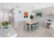Bright dining area features a light-toned wood table with ocean view and access to the main living area at 13500 Gulf Blvd # 506, Madeira Beach, FL 33708