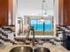 Granite countertops and mosaic tile backsplash adorn the modern kitchen overlooking the living room and ocean at 13500 Gulf Blvd # 506, Madeira Beach, FL 33708
