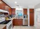 Well-equipped kitchen features stainless steel appliances and a pass-through window at 13500 Gulf Blvd # 506, Madeira Beach, FL 33708