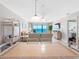 A modern living room boasts panoramic ocean views, comfortable seating, and access to a private balcony at 13500 Gulf Blvd # 506, Madeira Beach, FL 33708