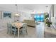 Well-lit living room and dining area showcases ocean views, comfortable seating, and tiled floors at 13500 Gulf Blvd # 506, Madeira Beach, FL 33708