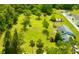 Expansive green acreage features playground, red structure, and charming home; a serene, outdoor haven at 14318 Guava St, Hudson, FL 34667