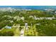 An aerial view showcases a residential neighborhood, revealing homes surrounded by trees and waterfront access at 14318 Guava St, Hudson, FL 34667