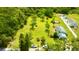 Aerial view of a property highlighting a house, lush greenery, and a spacious lawn on a sunny day at 14318 Guava St, Hudson, FL 34667