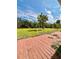 Spacious backyard and a wooden deck with a green lawn at 14318 Guava St, Hudson, FL 34667