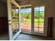 View from inside looking out onto a spacious backyard and a wooden deck with a red outbuilding at 14318 Guava St, Hudson, FL 34667