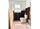Bathroom featuring a shower-tub combo, toilet and window with natural light at 14318 Guava St, Hudson, FL 34667