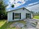 Exterior view of a light-colored house with dark shutters at 14318 Guava St, Hudson, FL 34667