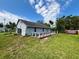 Home exterior featuring an expansive backyard and a wooden deck at 14318 Guava St, Hudson, FL 34667