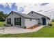 Charming home with inviting entrance, featuring potted flowers and a welcoming blue front door at 14318 Guava St, Hudson, FL 34667
