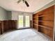 Versatile room with wood shelf, French doors, and ceiling fan at 14318 Guava St, Hudson, FL 34667