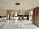 Spacious room with tile flooring, exposed studs, and a view into adjacent areas at 14318 Guava St, Hudson, FL 34667