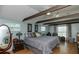 Spacious main bedroom features a large bed, dark wood floors, and serene, neutral decor at 14318 Guava St, Hudson, FL 34667