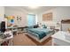 Nicely decorated bedroom with a large window, neutral carpet, and a cozy atmosphere at 15561 Stone House Dr, Brooksville, FL 34604