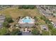 Aerial shot of a luxurious community pool area, complete with seating, landscaping, and recreational facilities at 15561 Stone House Dr, Brooksville, FL 34604