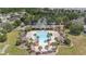 Upscale community pool area with palm trees, cabanas, and ample lounge seating for residents to enjoy at 15561 Stone House Dr, Brooksville, FL 34604