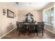 Elegant dining room with a dark wood table, chandelier, and large window providing natural light at 15561 Stone House Dr, Brooksville, FL 34604