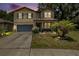 Charming two-story home featuring neutral paint, a garage, and a well-maintained front yard at 15561 Stone House Dr, Brooksville, FL 34604