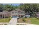 Charming two-story home with a well-manicured lawn and inviting curb appeal in a Gathering-friendly neighborhood at 15561 Stone House Dr, Brooksville, FL 34604