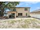 Rear exterior view of the home with a covered patio and spacious yard at 15561 Stone House Dr, Brooksville, FL 34604