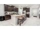 This stunning kitchen features a center island, dark cabinets, and white subway tile backsplash at 15561 Stone House Dr, Brooksville, FL 34604
