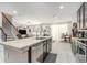 Open concept kitchen with center island, stainless steel appliances, and views into the living room at 15561 Stone House Dr, Brooksville, FL 34604