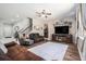 Inviting living room with stylish furniture, a ceiling fan, and large windows allowing ample natural light at 15561 Stone House Dr, Brooksville, FL 34604