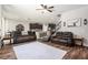 Cozy living room with comfortable seating, ceiling fan, and seamless flow to the kitchen at 15561 Stone House Dr, Brooksville, FL 34604