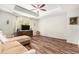 Spacious living room featuring modern wood flooring, a tray ceiling, and a comfortable sofa at 15561 Stone House Dr, Brooksville, FL 34604