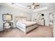 Spacious main bedroom featuring a tray ceiling, neutral-toned decor, and soft natural light at 15561 Stone House Dr, Brooksville, FL 34604
