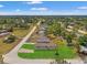 Aerial view of a single-story home in a rural neighborhood with a green lawn at 16070 La Bella St, Brooksville, FL 34604