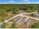 A clear aerial shot of mobile homes with green trees and gravel roads on a sunny day at 16070 La Bella St, Brooksville, FL 34604