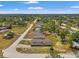 This is an aerial view of a home on a lot surrounded by trees and other residences in the community at 16070 La Bella St, Brooksville, FL 34604