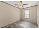 Cozy bedroom featuring a ceiling fan, natural light from the window, and neutral walls at 16070 La Bella St, Brooksville, FL 34604