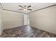 Bedroom with a ceiling fan and dark wood-look floors, and doorway view to another room at 16070 La Bella St, Brooksville, FL 34604