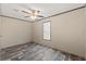 A bedroom with brown floors, white walls, and natural light from the window at 16070 La Bella St, Brooksville, FL 34604