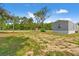Exterior of property with a spacious front yard featuring natural landscaping and gravel at 16070 La Bella St, Brooksville, FL 34604