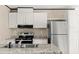 Kitchen with stainless steel refrigerator, sink, oven and white cabinets at 16070 La Bella St, Brooksville, FL 34604