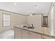 Bright kitchen with a double basin sink with a granite countertop and natural light at 16070 La Bella St, Brooksville, FL 34604