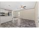 Bright living room with wood floors, ceiling fan, and modern decor at 16070 La Bella St, Brooksville, FL 34604