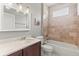 A clean and well-maintained bathroom featuring tub with tile surround and granite vanity at 1611 Cresson Ridge Ln, Brandon, FL 33510