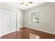 This bedroom features wood floors, a closet and a large window at 1611 Cresson Ridge Ln, Brandon, FL 33510