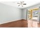A well-lit bedroom with hardwood floors and sliding glass doors leading to a screened patio at 1611 Cresson Ridge Ln, Brandon, FL 33510