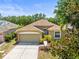 Charming single-story home features a well-manicured lawn, lovely landscaping, and an attached two-car garage at 1611 Cresson Ridge Ln, Brandon, FL 33510