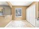Bright eat-in kitchen boasts tile flooring, a double-door pantry, and a window overlooking the backyard at 1611 Cresson Ridge Ln, Brandon, FL 33510