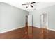 A large, bright main bedroom featuring hardwood floors, neutral paint, and ceiling fan at 1611 Cresson Ridge Ln, Brandon, FL 33510