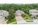 Aerial view of a well-maintained home with a three-car garage and beautiful landscaping at 19312 Sunset Bay Dr, Land O Lakes, FL 34638