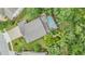 Aerial view of a home with screened pool, large backyard, and lush surrounding landscape at 19312 Sunset Bay Dr, Land O Lakes, FL 34638