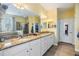 Bright bathroom featuring a double vanity with granite countertops, a walk-in closet, and a shower with a tub at 19312 Sunset Bay Dr, Land O Lakes, FL 34638